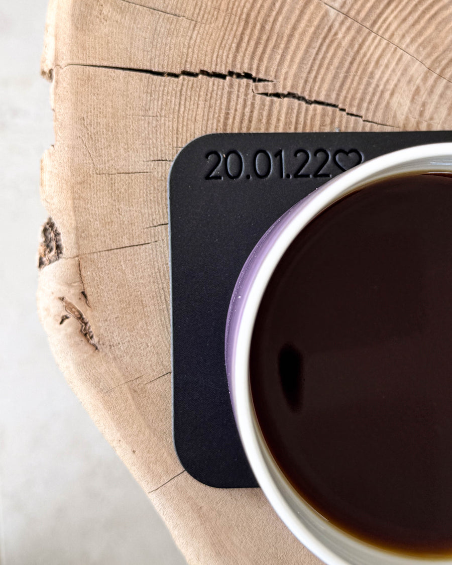 MOKKA firkantet bordskåner i sort læder med personlig gravering "20.01.22" ♡ under kaffekop på træskive
