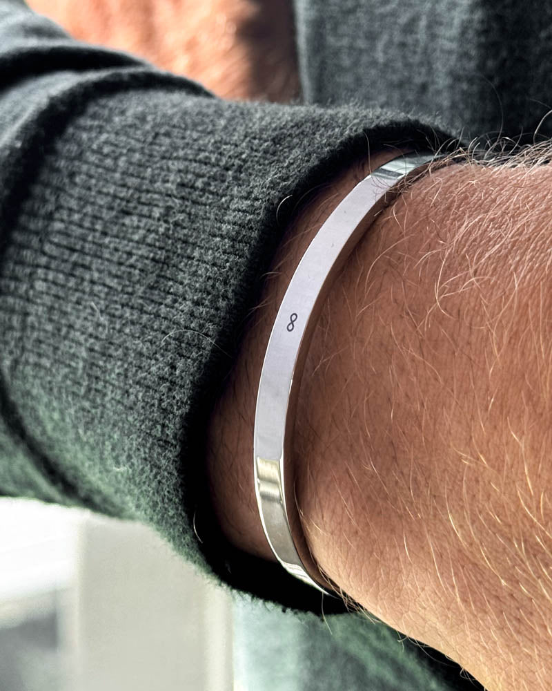 MARS armbånd i sølvfarvet rustfrit stål med uendelighedstegn ∞ graveret om håndleddet, mørkegrøn strik
